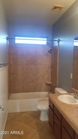 a bathroom with a granite countertop sink a toilet and bathtub