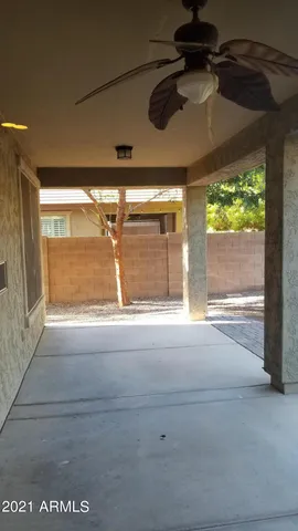 a view of room with a floor to ceiling window and a ceiling fan