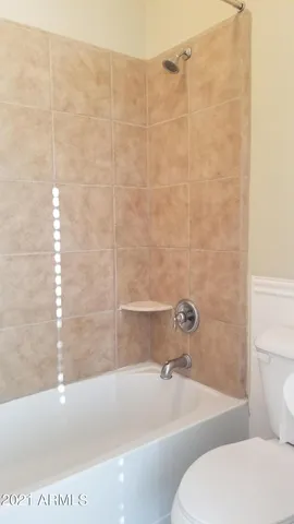 a bath tub sitting next to a white toilet