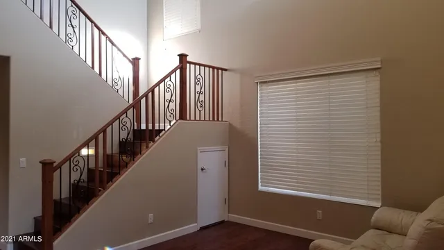 a view of staircase with wooden floor and a window