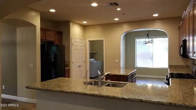a living room with hard wood floors and gym equipment
