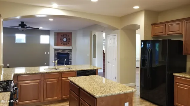 a kitchen with a sink a refrigerator and cabinets