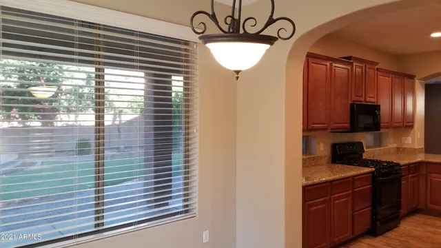 a kitchen with a window a sink and a refrigerator