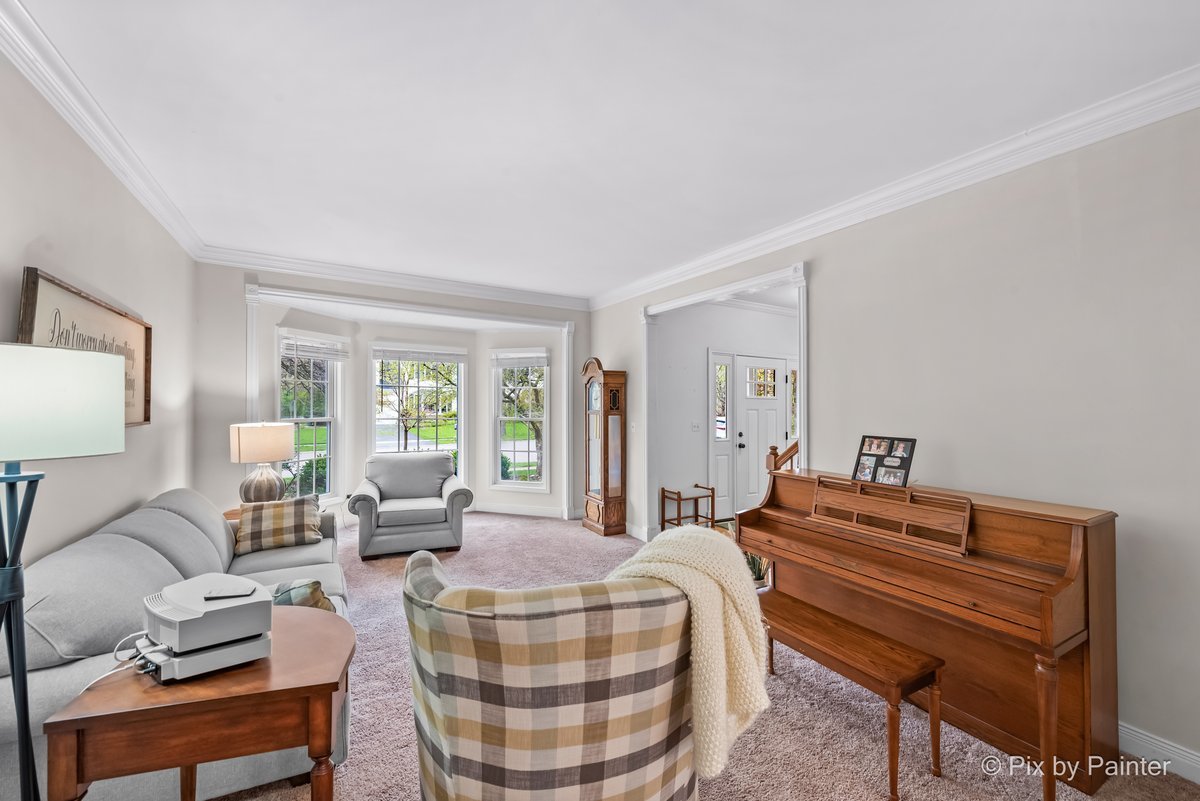 249 Adare Drive Cary, IL 60013 - Photo 13 of 36 a living room with furniture a large window and a lamp