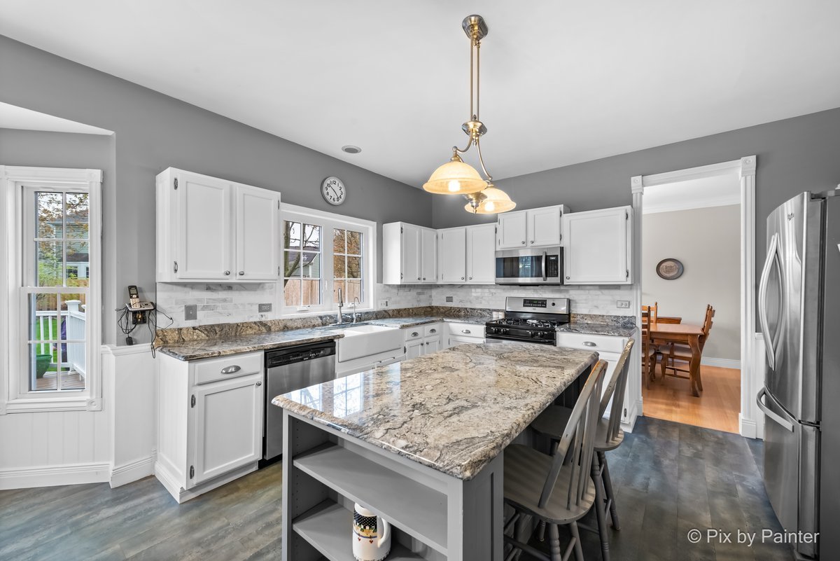 249 Adare Drive Cary, IL 60013 - Photo 16 of 36 a kitchen with granite countertop lots of counter top space and stainless steel appliances