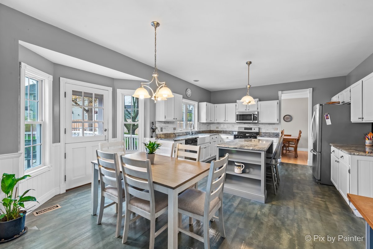 249 Adare Drive Cary, IL 60013 - Photo 20 of 36 a open dining room with stainless steel appliances furniture a window and wooden floor
