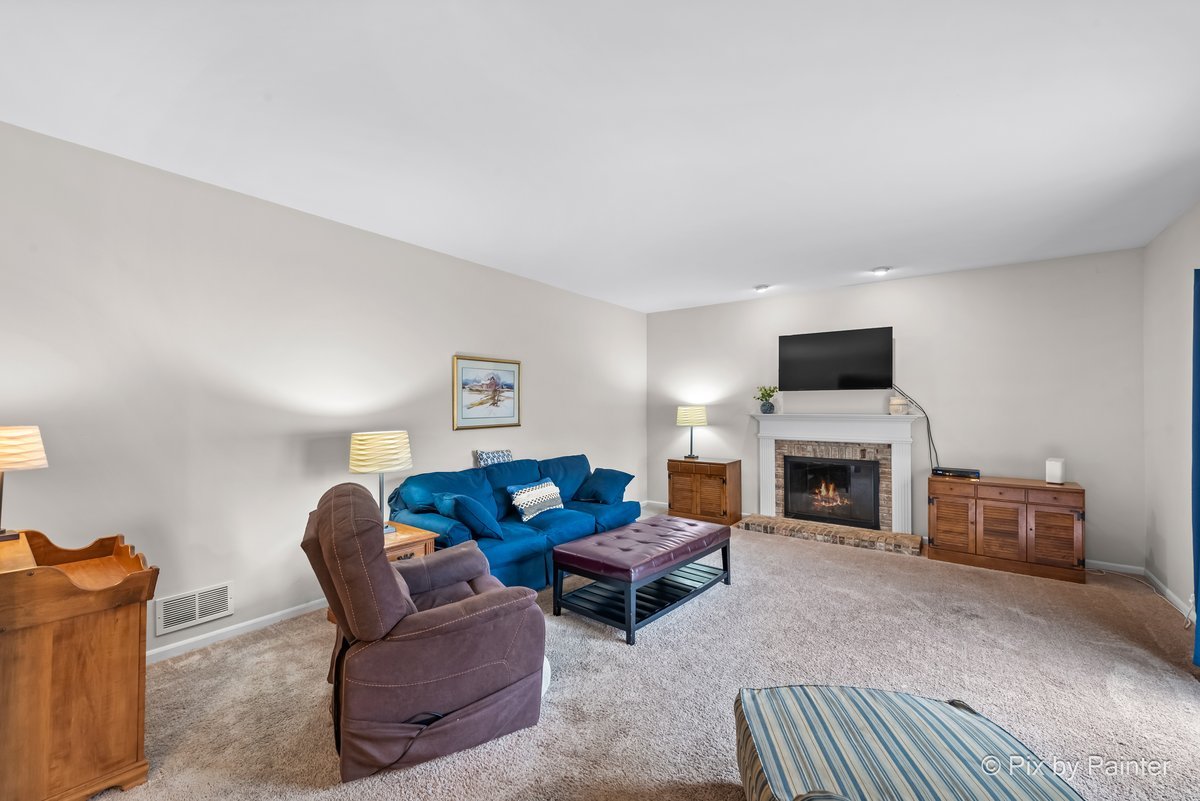 249 Adare Drive Cary, IL 60013 - Photo 21 of 36 a living room with furniture a fireplace and a flat screen tv