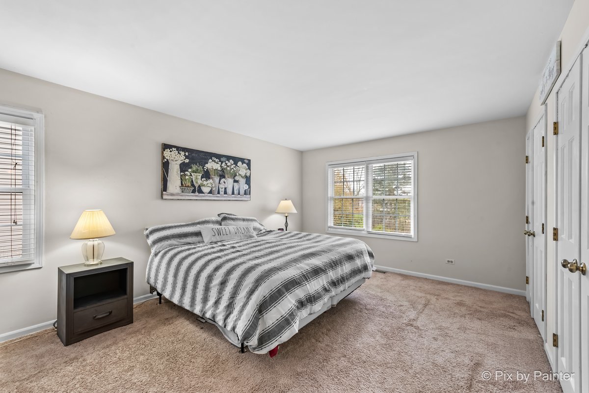 249 Adare Drive Cary, IL 60013 - Photo 29 of 36 a bedroom with a bed and a lamp on dresser