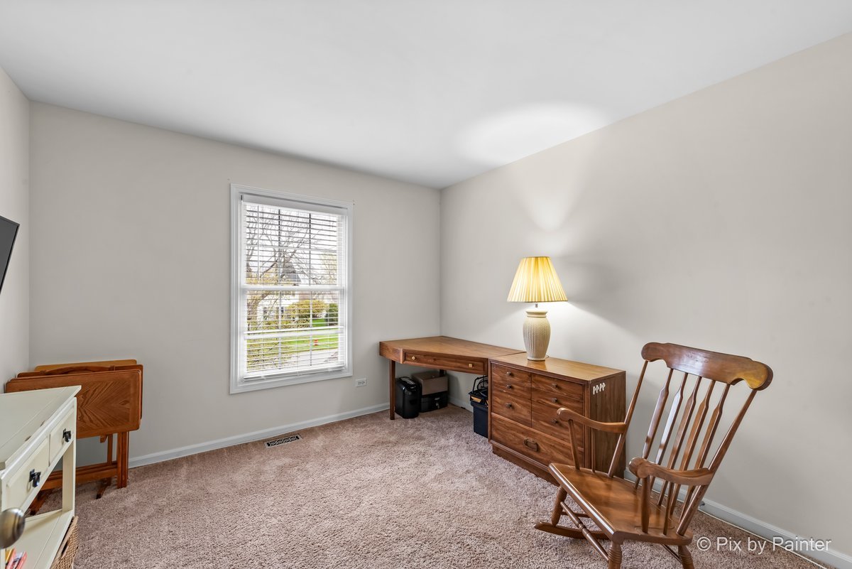 249 Adare Drive Cary, IL 60013 - Photo 33 of 36 a room with a window and a chair