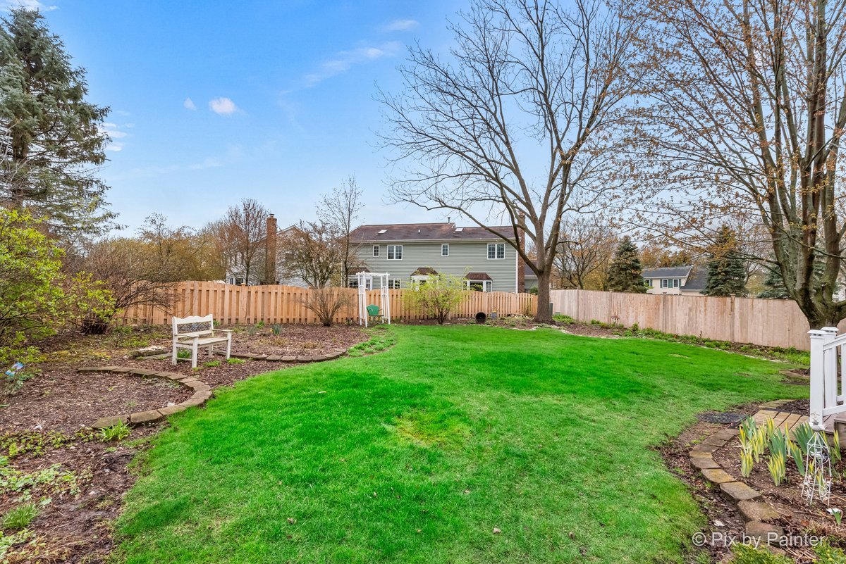 249 Adare Drive Cary, IL 60013 - Photo 6 of 36 a view of a yard with a house and a large tree