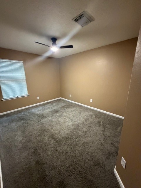 8626 Valley Crest Lane Houston, TX 77075 - Photo 12 of 14 an empty room with a ceiling fan and window