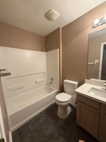 a bathroom with a toilet a sink and bathtub