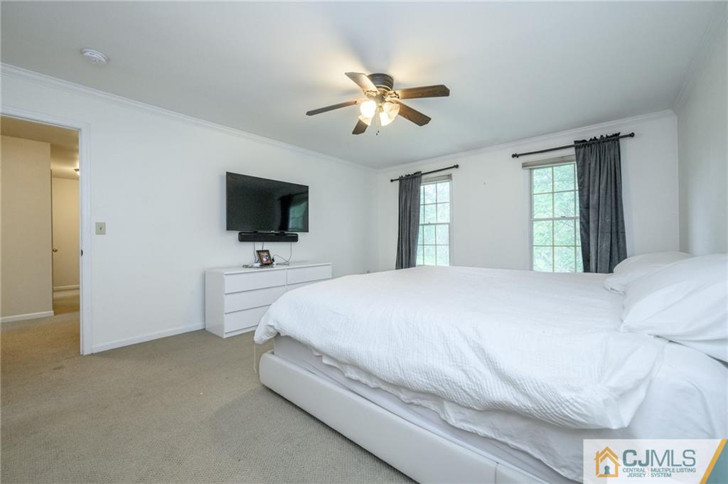 9 Pebble Beach Way Washington, NJ 07882 - Photo 23 of 42 a spacious bedroom with a bed and a flat screen tv