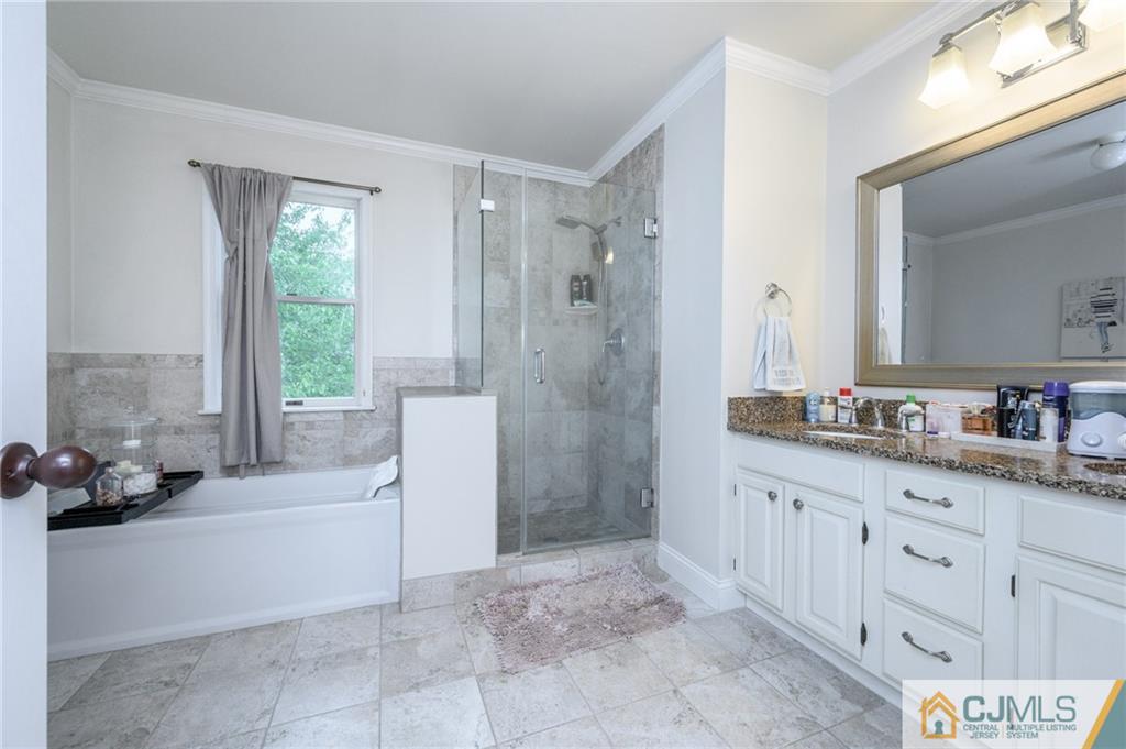 9 Pebble Beach Way Washington, NJ 07882 - Photo 25 of 42 a bathroom with a tub sink and mirror