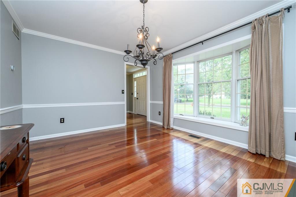 9 Pebble Beach Way Washington, NJ 07882 - Photo 3 of 42 a view of an empty room with wooden floor and a window