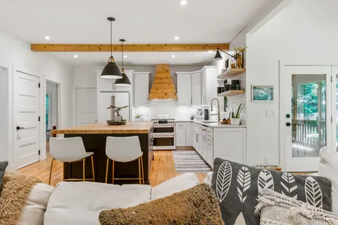 a living room with fireplace furniture and a fireplace