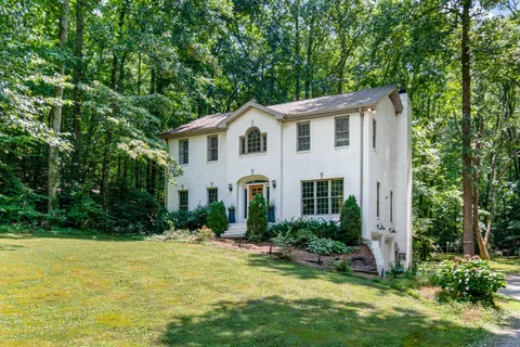 a view of a hallway with wooden floor and entryway