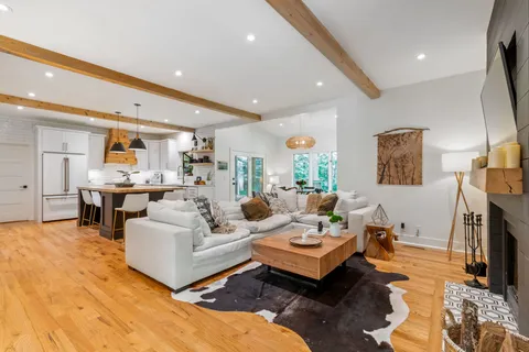 a living room with furniture and wooden floor