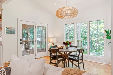 a bedroom with a bed a television and a large window