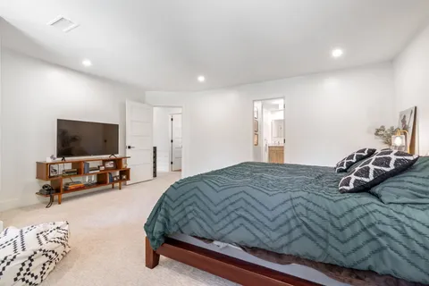 a living room with furniture and floor to ceiling windows