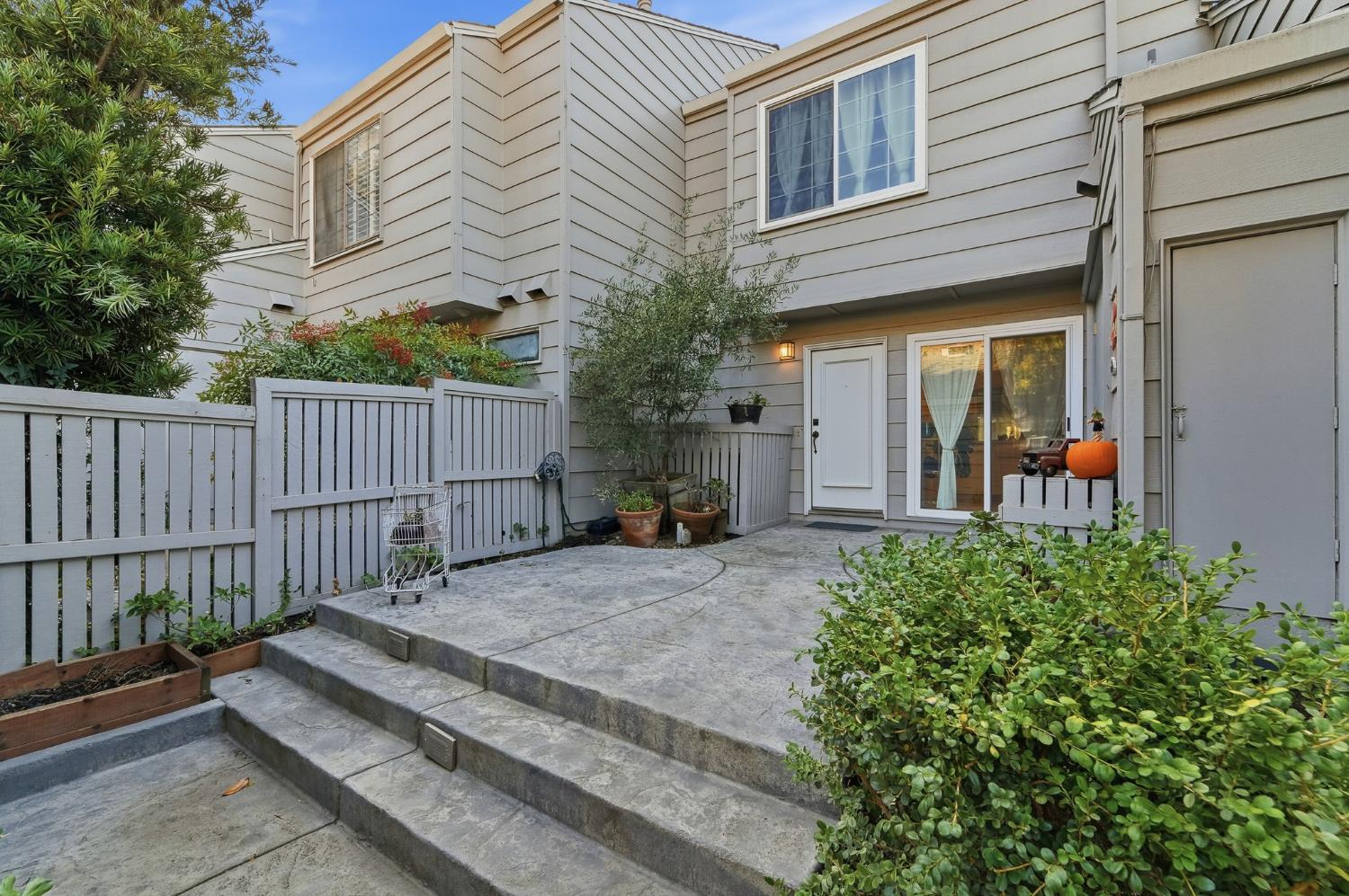 a view of a house with a small yard and plants
