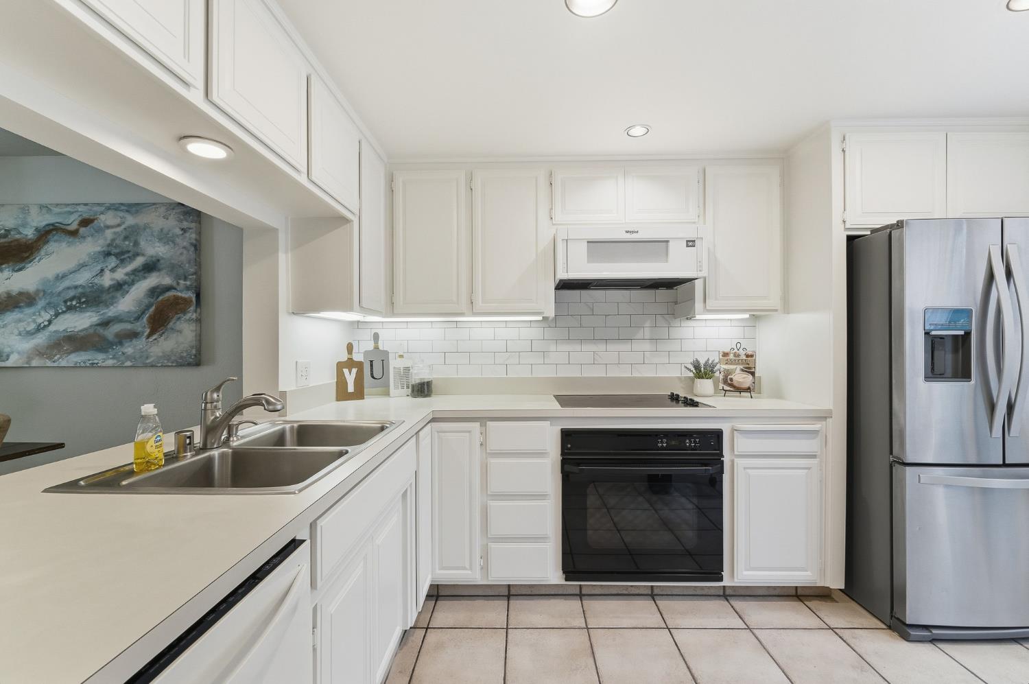 230 West Rumble Road, Unit C Modesto, CA 95350 - Photo 14 of 54 a kitchen with a sink stove and refrigerator