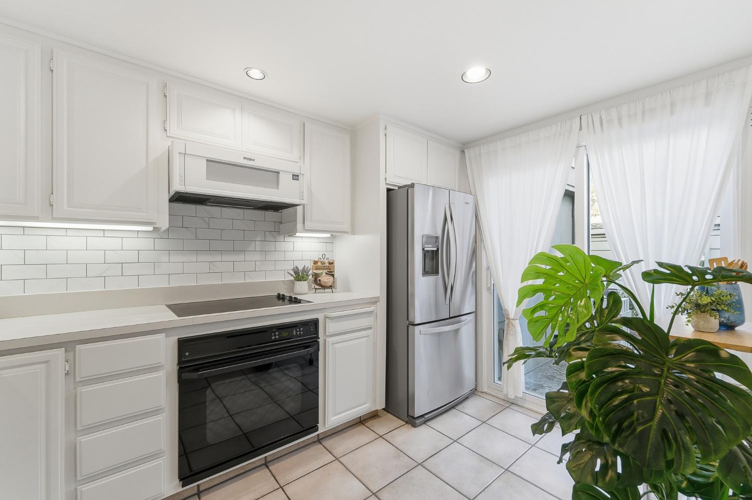 230 West Rumble Road, Unit C Modesto, CA 95350 - Photo 19 of 54 a kitchen with stainless steel appliances a refrigerator sink and wooden cabinets