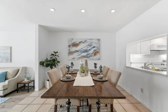 a living room with furniture a fireplace and a potted plant