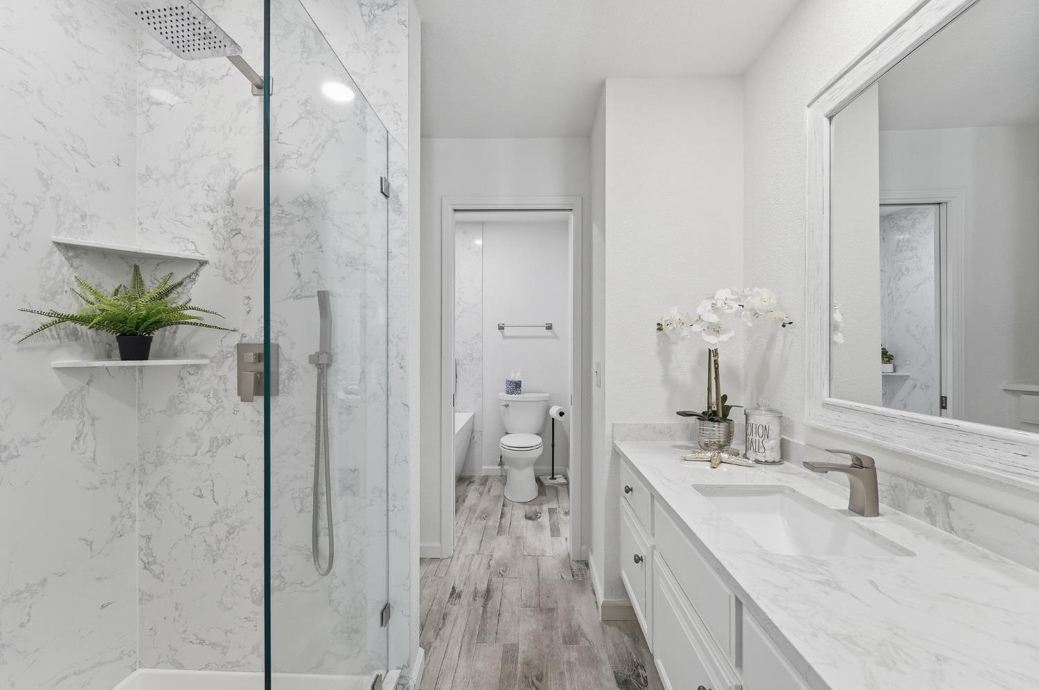 230 West Rumble Road, Unit C Modesto, CA 95350 - Photo 36 of 54 a bathroom with a granite countertop sink mirror and shower