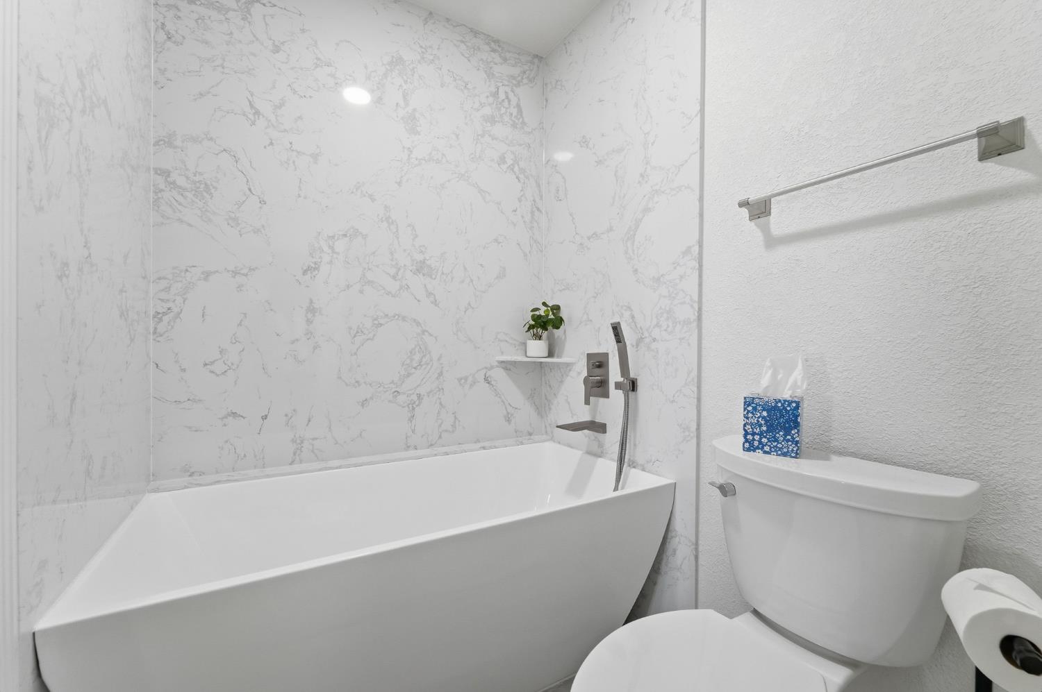 230 West Rumble Road, Unit C Modesto, CA 95350 - Photo 39 of 54 a white toilet and tub sitting next to a bathroom sink