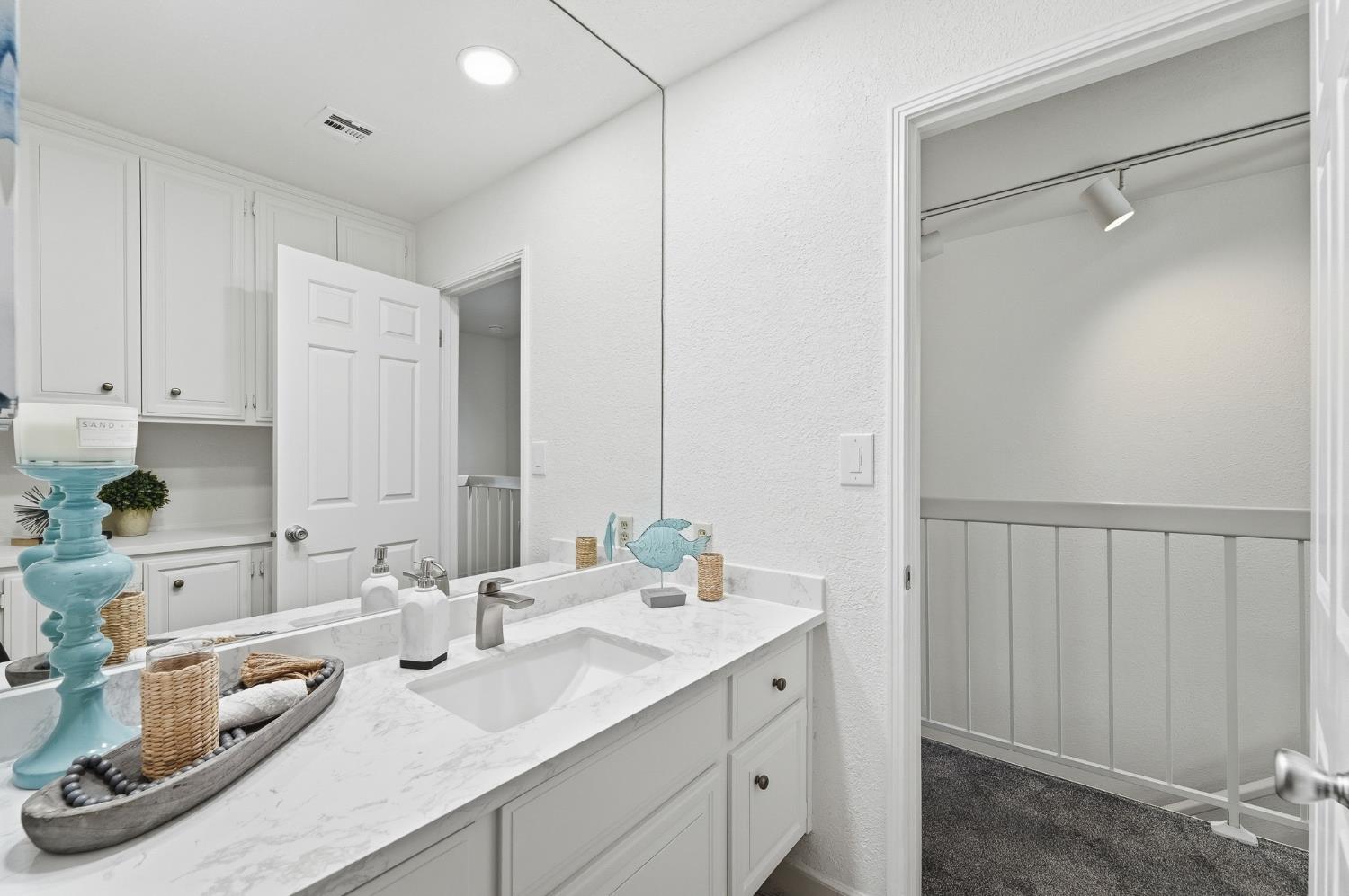 230 West Rumble Road, Unit C Modesto, CA 95350 - Photo 40 of 54 a bathroom with a sink and a mirror