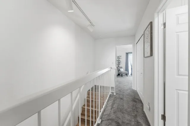 a patio with a table and chairs under an umbrella