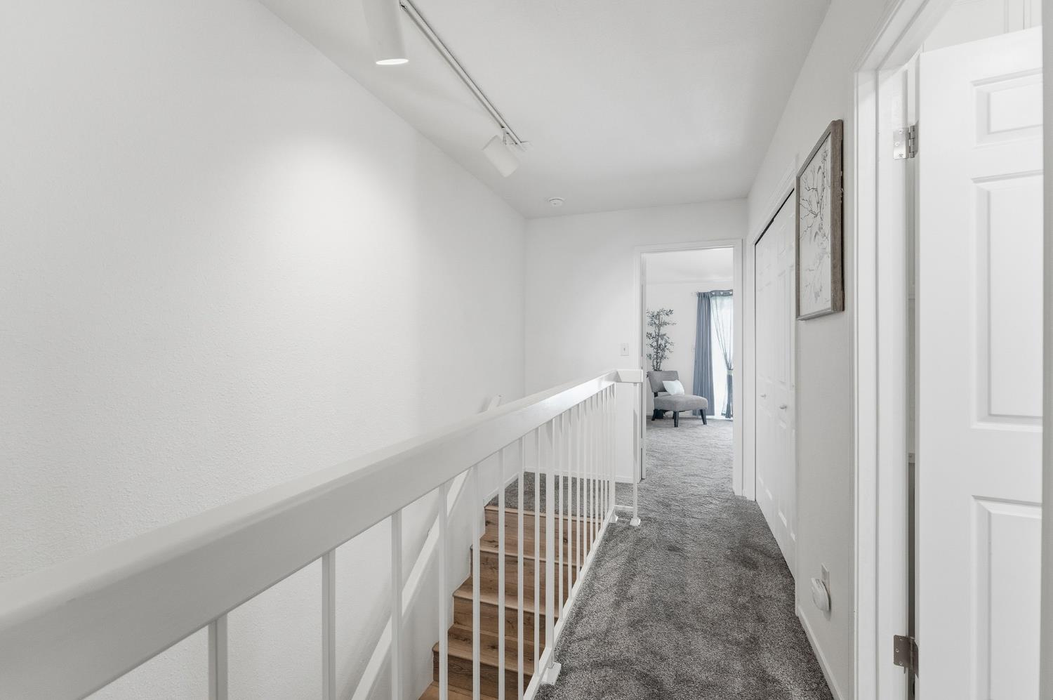 230 West Rumble Road, Unit C Modesto, CA 95350 - Photo 45 of 54 a view of a hallway with wooden floor and staircase