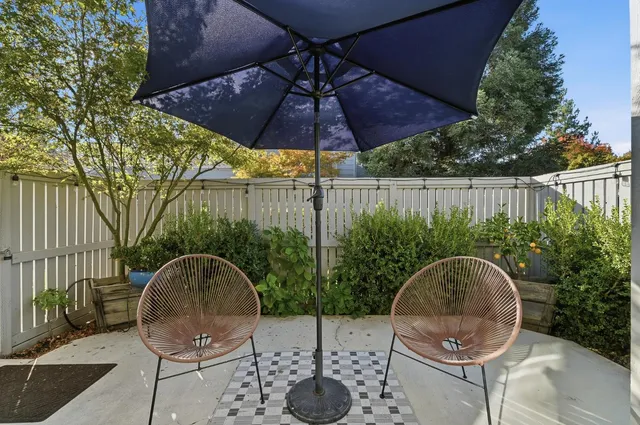 a patio table and chairs under an umbrella