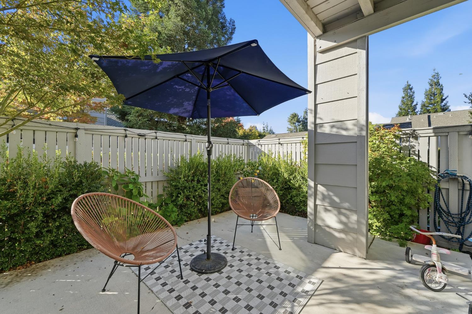 230 West Rumble Road, Unit C Modesto, CA 95350 - Photo 50 of 54 a patio table and chairs under an umbrella