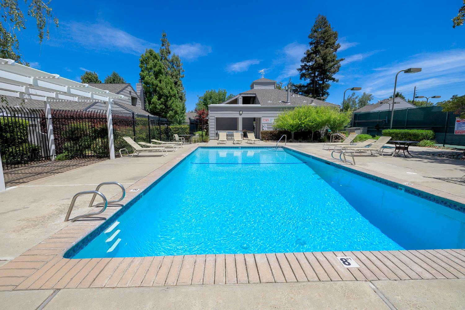 230 West Rumble Road, Unit C Modesto, CA 95350 - Photo 54 of 54 a view of a swimming pool with a lounge chairs