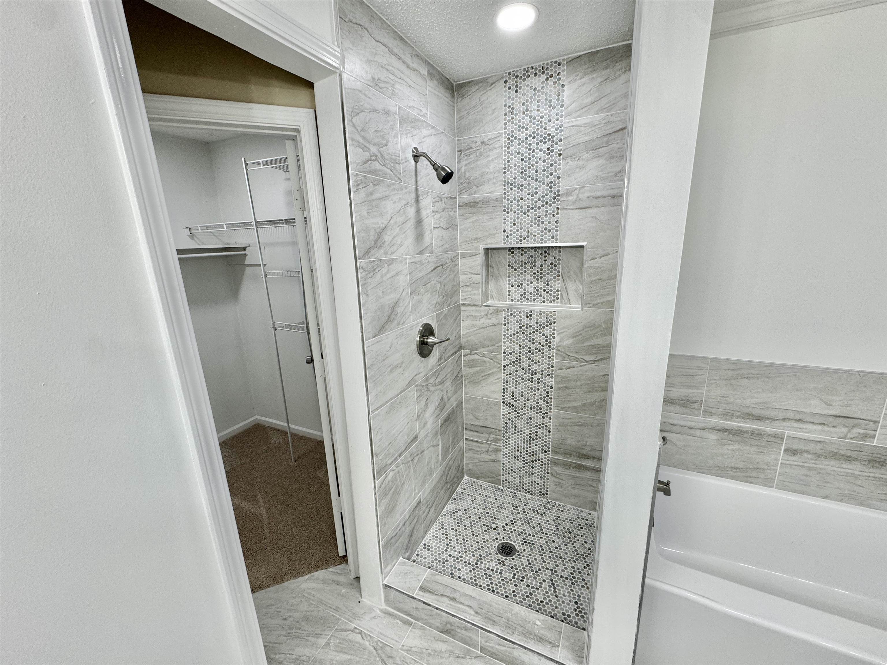 6889 Fulton Road Brownsville, TN 38012 - Photo 21 of 40 Bathroom featuring a textured ceiling and tiled shower