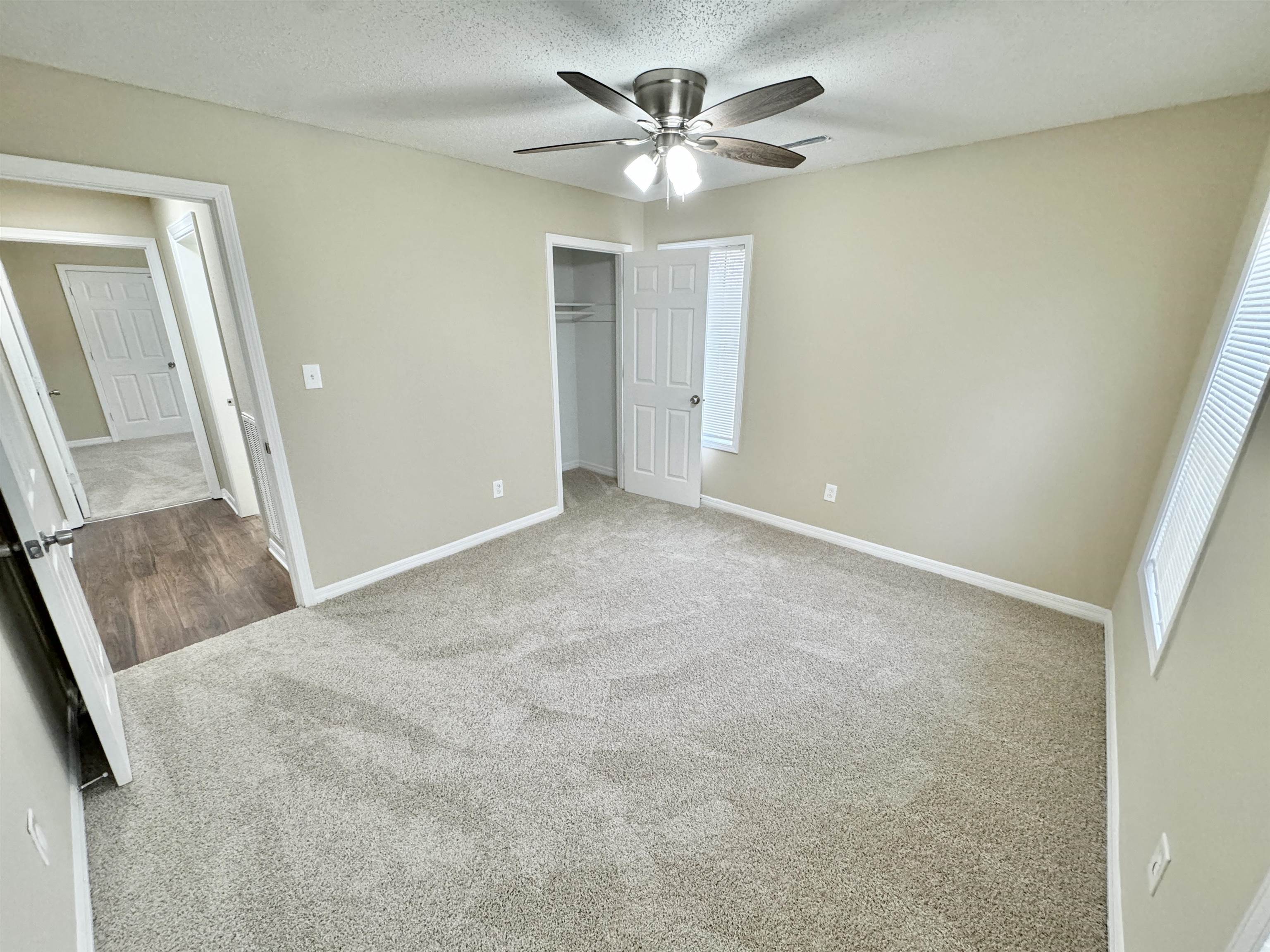 6889 Fulton Road Brownsville, TN 38012 - Photo 24 of 40 Unfurnished bedroom with ceiling fan, a closet, a textured ceiling, and carpet