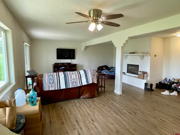 a living room with furniture fireplace and wooden floor