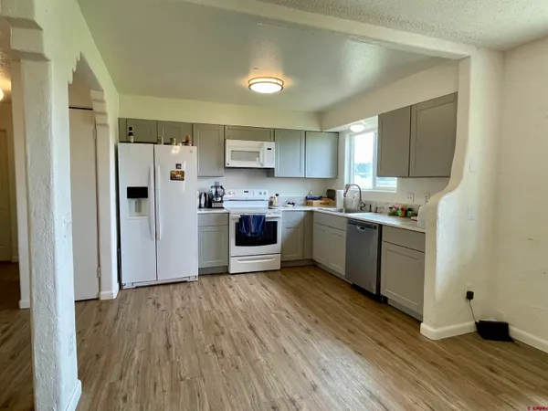 a kitchen with a white cabinets and white appliances