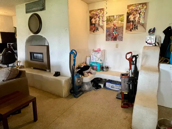 a living room with furniture a mirror and a fireplace