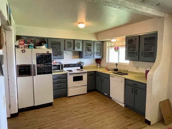 a kitchen with stainless steel appliances a stove a sink and a refrigerator