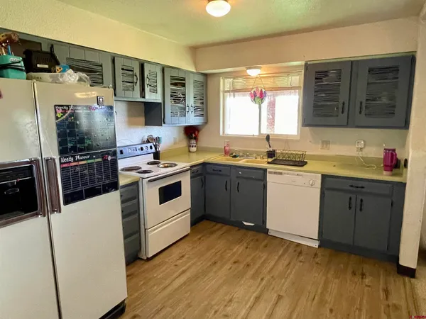 a kitchen with a sink stove and wooden cabinets