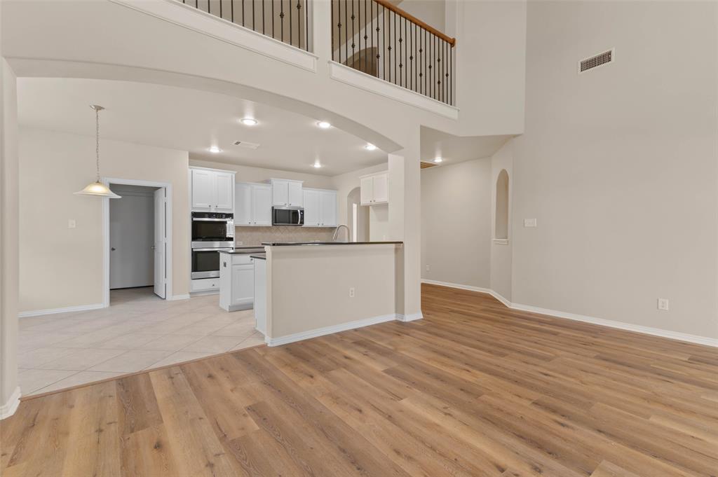7509 Barrymore Road Denton, TX 76208 - Photo 9 of 40 Living room open to kitchen