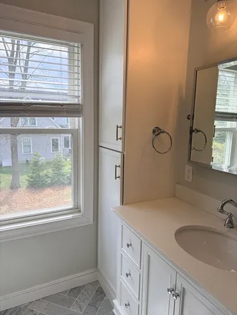a bathroom with a sink and a large mirror