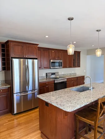 a kitchen with stainless steel appliances granite countertop a sink refrigerator and microwave