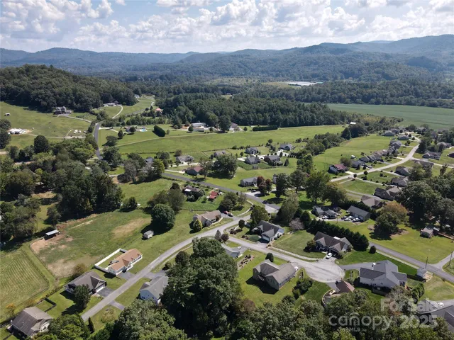 an aerial view of a town with mountains