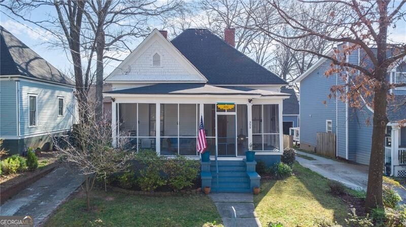 This home has charm for days and a delightful screen porch to perch on and watch passerby.