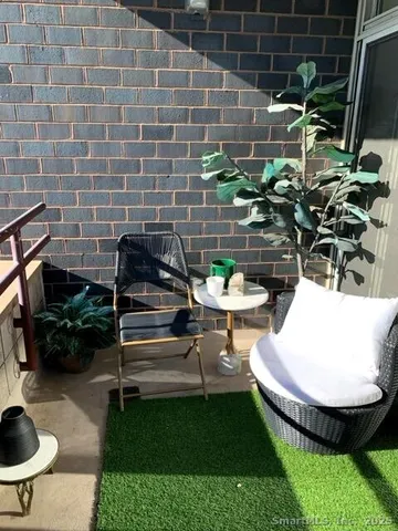a view of a backyard with plants and a patio