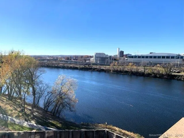 a view of roof deck with wooden floor and city view